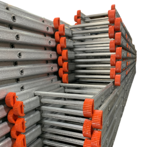 Stack of Tuff Steel 4m heavy-duty galvanised steel pole ladders with durable orange rubber feet for stability