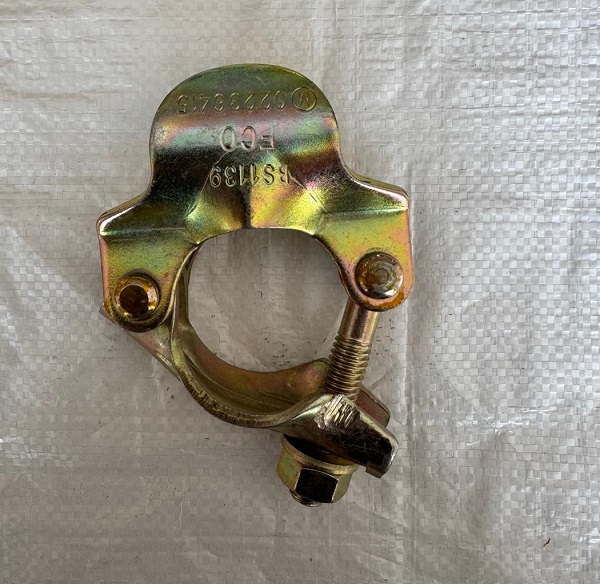 Close-up of a zinc-galvanized oyster coupler for scaffolding, with BS1139 compliance stamp, "ECO" branding, and a secure bolt-nut assembly on the 48.3mm tube clamp, ideal for creating level scaffold board platforms.