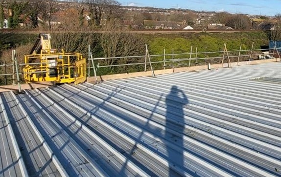 Handrail scaffold installed around the edge of a metal sheet roof at Grange Road, Shoreham